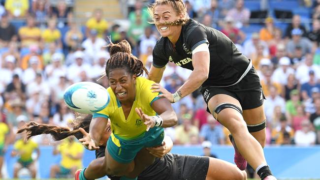 Australia’s Ellia Green passes out of a tackle during the gold medal match against New Zealand at Robina Stadium yesterday. Picture: AAP