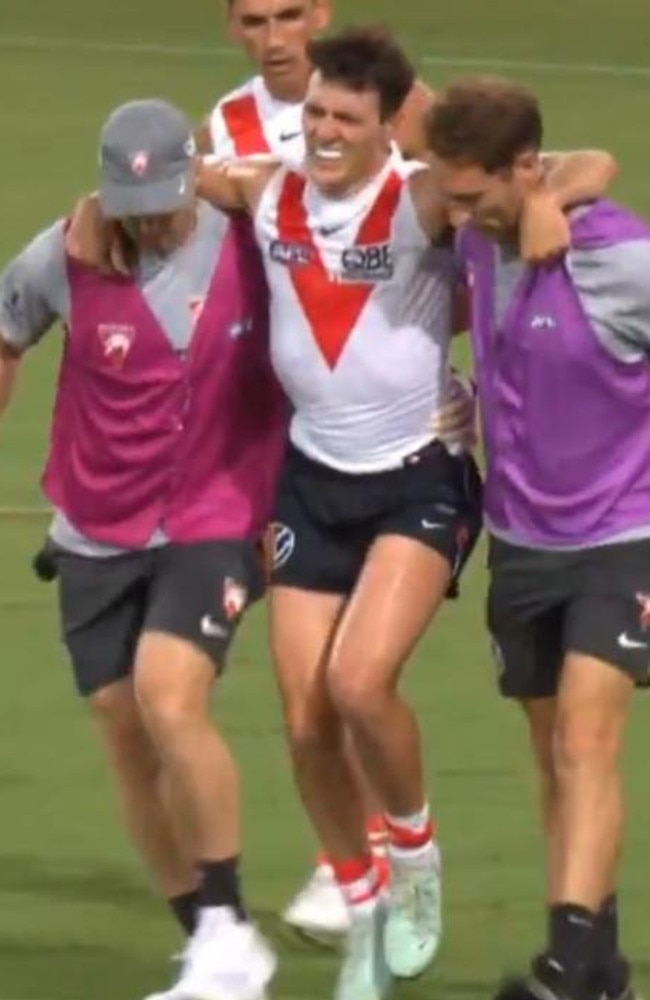 Errol Gulden is helped from the field after injuring his ankle