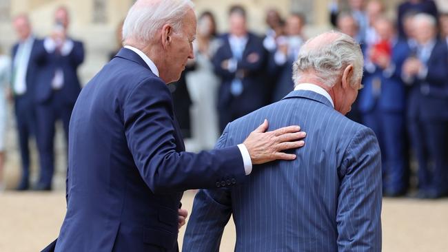 Joe Biden grabbed the 74-year-old monarch’s arm as they embraced and shook hands, then put his hand on his back during their lap of the quadrangle. Picture: Getty Images