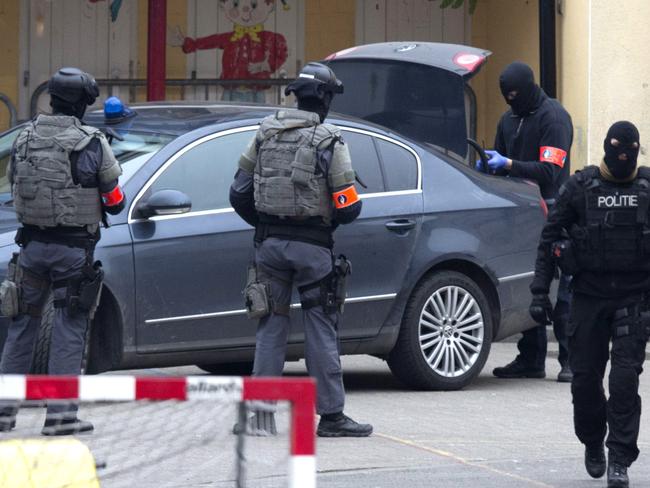 Closing in ... Special operations police secure an area during a police raid in the Molenbeek neighbourhood of Brussels, Belgium.  Picture:  AP