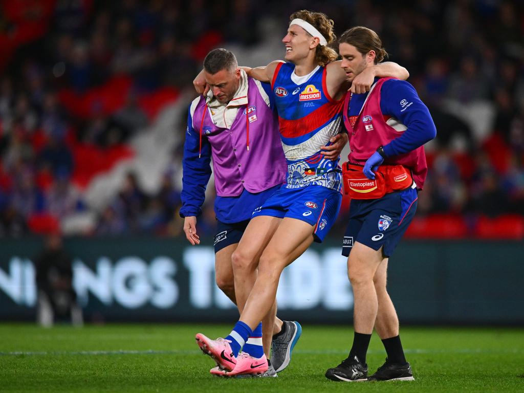 Aaron Naughton is carried from the field after being injured. Picture: Morgan Hancock/Getty Images