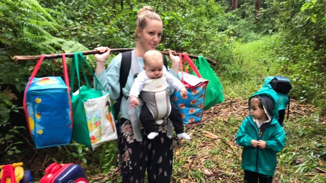 Lauren Archer and two of her three children trekking to safety through the rain forest in Upper Lansdowne.