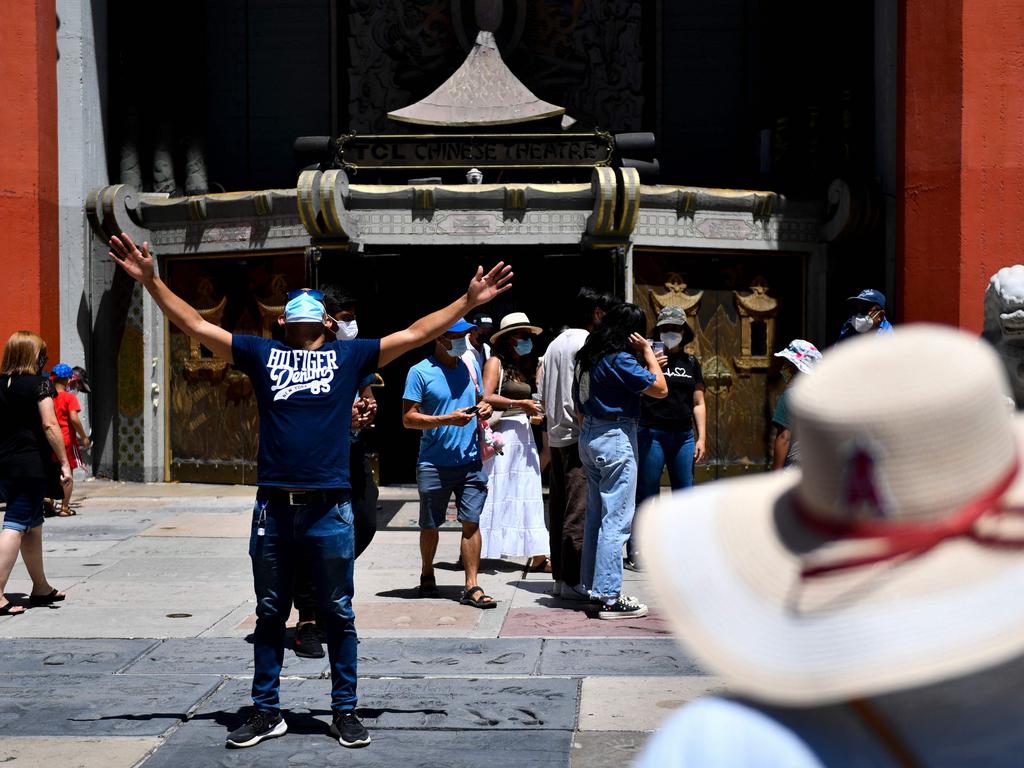 Tourists wear face masks outside of Grauman’s Chinese Theatre in Hollywood. The tourists may be back but America’s Covid cases are surging again. Picture: AFP