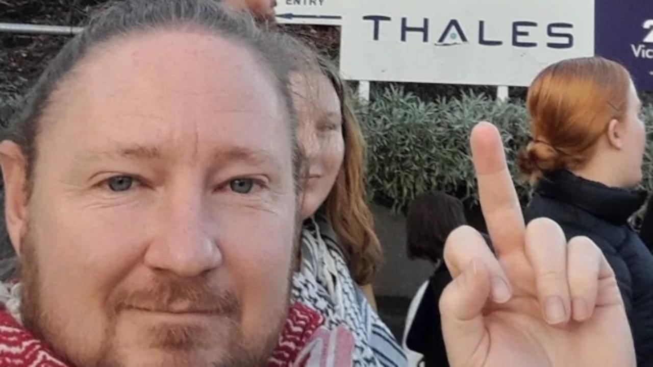 Serial activist Josh Lees, 41, was seen flicking the middle finger at a rally outside Thales Australia in Sydney, a subsidiary to French weapons manufacturer.