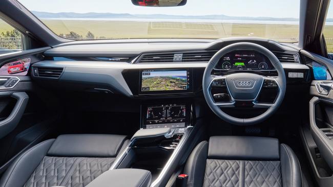 While the Audi e-Tron shifts into gear via a small sliding button, the biggest difference is no side mirrors. Check out the camera view embedded at the top of the doors.