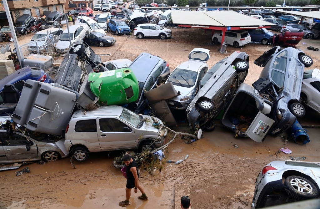 Wreckage of cars and debris are piled up in the streets of Paiporta