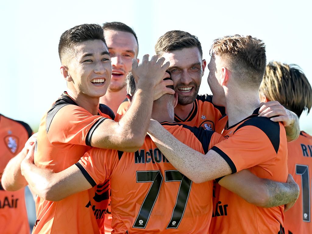 Scott McDonald (77) is congratulated by his Roar teammates after scoring a goal at Dolphin Stadium. Picture: Bradley Kanaris/Getty Images