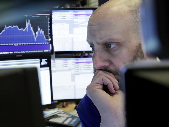 Trader Meric Greenbaum is framed by his monitors as he works on the floor of the New York Stock Exchange, Thursday, March 22, 2018. Stocks plunged, sending the Dow Jones industrials down more than 700 points, as investors feared that trade tensions will spike between the U.S. and China. (AP Photo/Richard Drew)