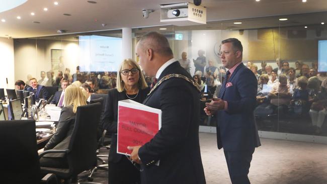 Deputy Mayor Donna Gates, Mayor Tom Tate and Cameron Caldwell before a packed gallery. Picture Glenn Hampson