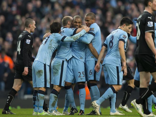 Manchester City's Fernandinho, centre left, celebrates with teammates after scoring.