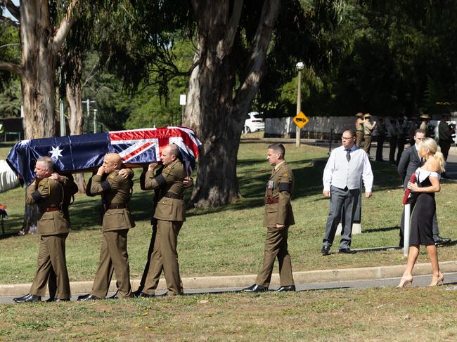 Erin Molan walks behind her dad Jim Molan’s coffin carrying his military medals. Picture: NCA NewsWire / Gary Ramage