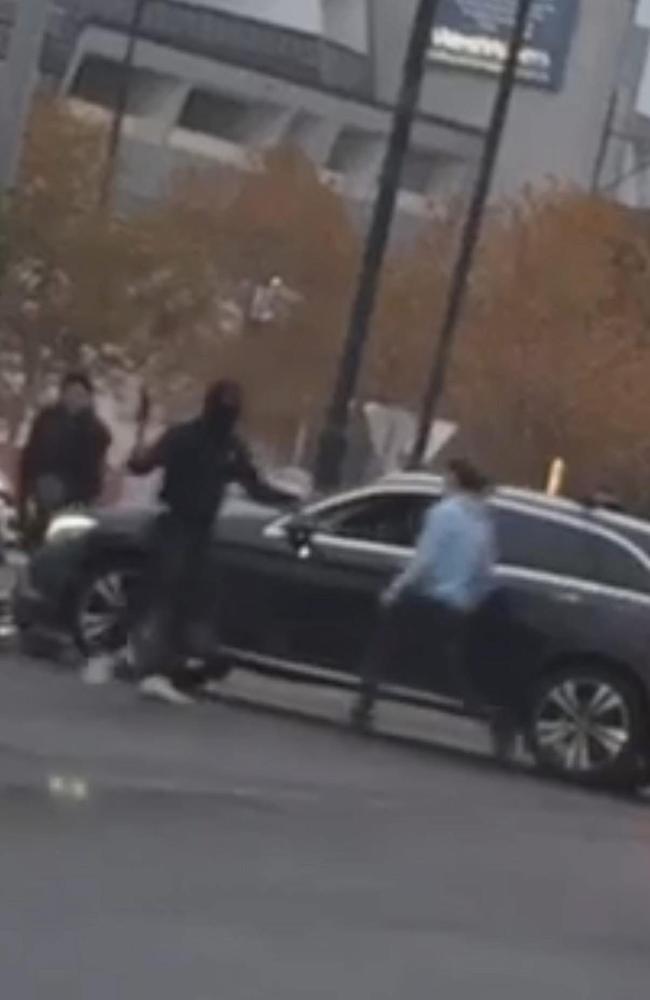 The five teenagers were seen running frantically through the carpark, waving their machetes. Picture: Supplied