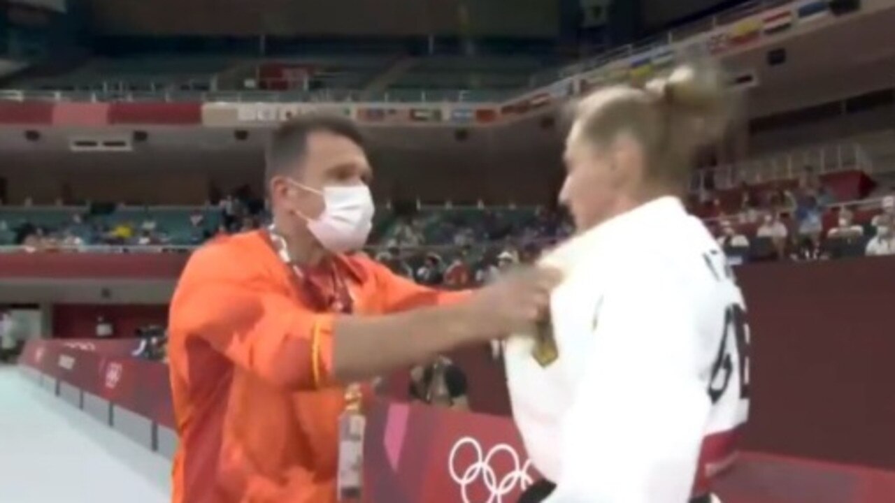 The coach of German judoka Martyna Trajdos fires up his athlete before competing.