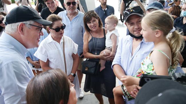 Prime Minister Scott Morrison and his wife Jenny Morrison meet Gold Coast tourists Joanne Grady, Amelia Wells, 14 months, Scott Wells and Piper Wells, 5, at the Cairns Marlin Marine before heading to Green Island off Cairns. Picture: Brendan Radke