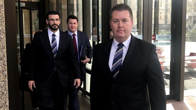 Officer in charge Sergeant Darren Gunn (far right) and detectives leave the NSW Supreme Court in Sydney after Daniel Holdom pleaded guilty. Picture: Emma Partridge