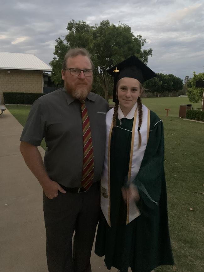 Abigail McAllister with her father Bruce McAllister who is an English teacher at Victory College, celebrating finishing 12 years of schooling.