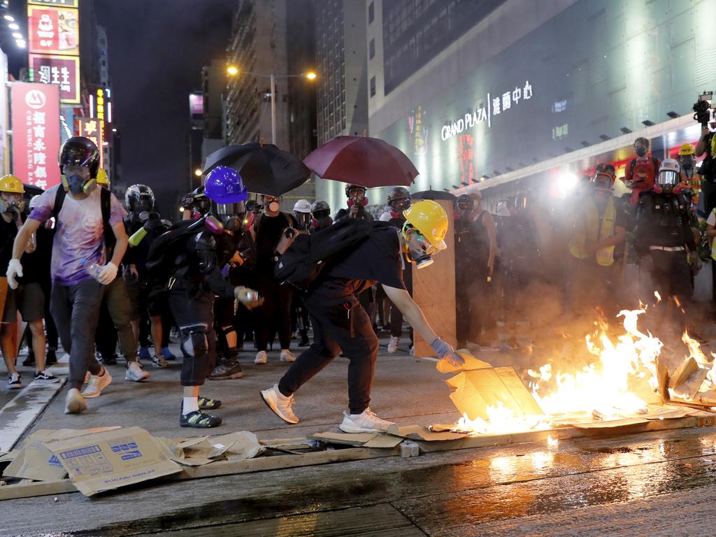 Protesters burn cardboard to form a barrier as they confront with police in Hong Kong. Picture: AP