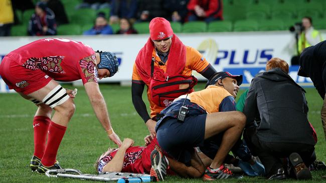 Reds captain James Horwill checks on the injured Dom Shipperley at AAMI Park.