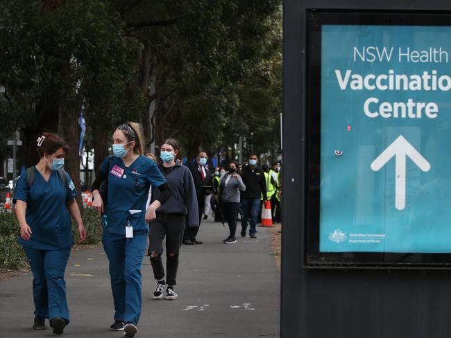 SYDNEY, AUSTRALIA - AUGUST 23: Medical workers are seen finishing a shift the New South Wales Health mass vaccination hub in Homebush on August 23, 2021 in Sydney, Australia. Further COVID-19 restrictions have come into effect across Greater Sydney as the state continues to grapple with rising COVID-19 case numbers in the community. As of 12:01 am Monday, face masks are now mandatory outdoors across NSW unless exercising, while a curfew in Sydney's hot spot suburbs in the west and south-west has been introduced between 9 pm and 5 am. Residents in local government areas of concern will also be limited to one hour of outdoor exercise per day while a raft of new rules for people working hot spot areas has also been introduced, including requiring worker permits. (Photo by Lisa Maree Williams/Getty Images)