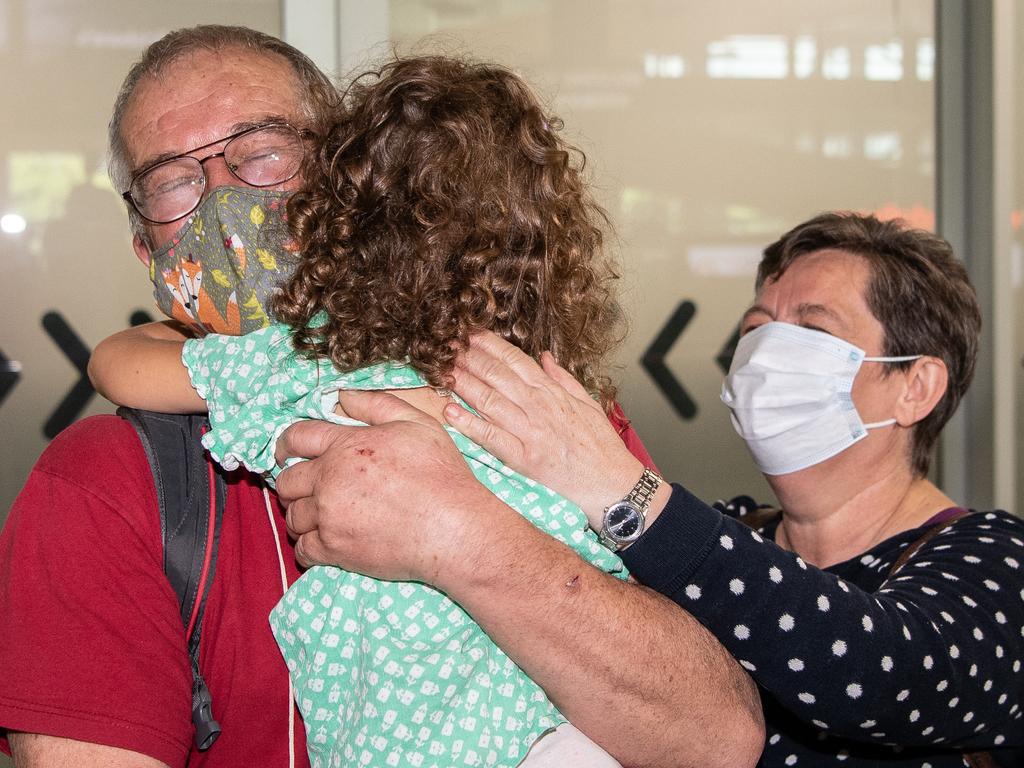 Rudolf and Julianna Nemeth hug their grand daughter Lili Kaity, 5, and Brisbane International airport as borders re-open. Picture: Brad Fleet