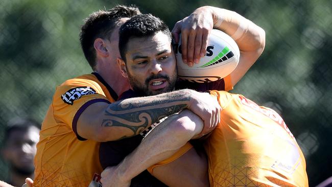 BRISBANE, AUSTRALIA - JULY 29: Ben Te'o is wrapped up by the defence during a Brisbane Broncos NRL training session at the Clive Berghofer Centre on July 29, 2020 in Brisbane, Australia. (Photo by Bradley Kanaris/Getty Images)