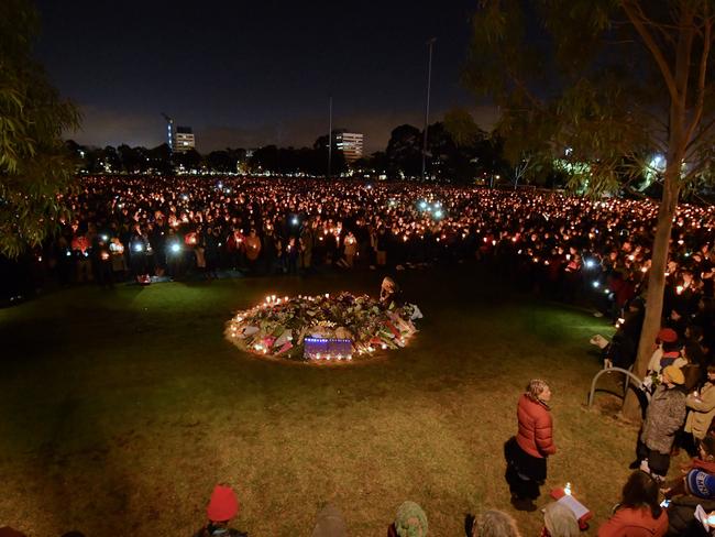 Thousands stand in solidarity after the floodlights were turned off at the vigil for Eurydice Dixon. Picture: Jason Edwards