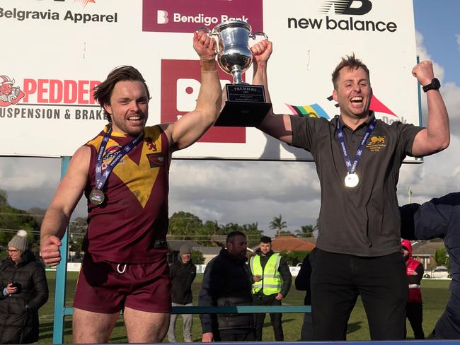 Michael Kinsella (R) and Jordan Pollard lift the 2024 premiership cup. Picture: Valeriu Campan