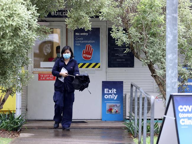 A NSW health worker leaves a testing clinic opposite Concord Repatriation General Hospital that is closed off to visitors due to a COVID-19 cluster. Picture: NCA NewsWire