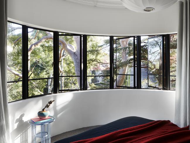 Original features were retained at the front of the house including the stunning curved window. Picture: Luc Remond