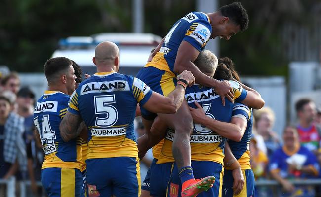 Waqa Blake of the Eels jumps on his team mates after a Mitchell Moses try (Photo by Albert Perez/Getty Images)