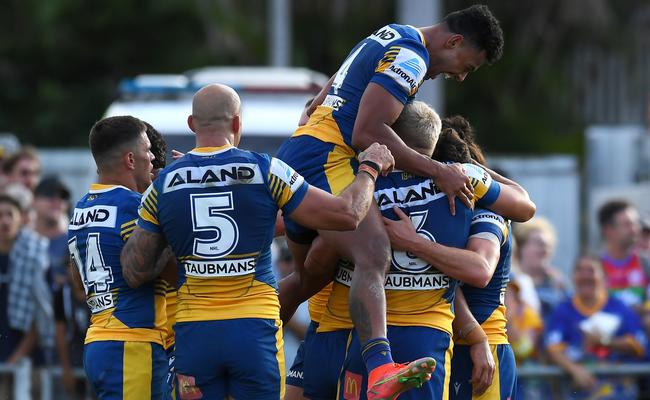 Waqa Blake of the Eels jumps on his team mates after a Mitchell Moses try (Photo by Albert Perez/Getty Images)