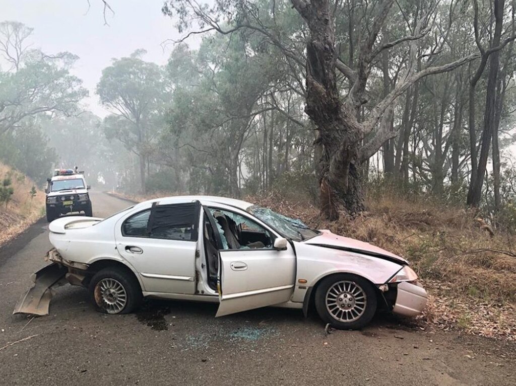 A 19-year-old accused looter is under police guard after crashing this stolen Ford Falcon into a tree at Batlow in the Snowy Valley. Picture: NSW Police