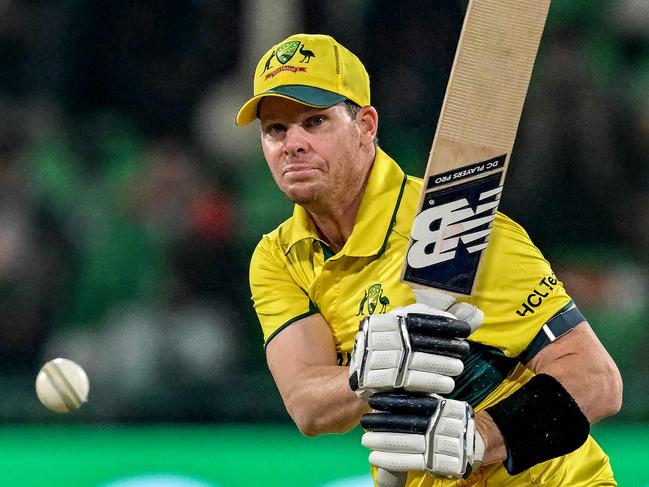 Australia's captain Steve Smith watches the ball after playing a shot during the ICC Champions Trophy one-day international (ODI) cricket match between Australia and Afghanistan at the Gaddafi Stadium in Lahore on February 28, 2025. (Photo by Aamir QURESHI / AFP)