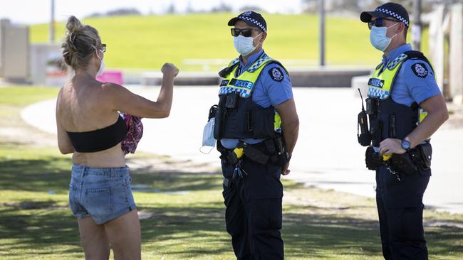 Police speak to a member of the public in Perth, Australia on Monday. Picture: Getty Images