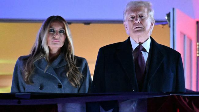 US President-elect Donald Trump and his wife Melania Trump get ready to watch fireworks in his honour at Trump National Golf Club Washington DC. Picture: AFP