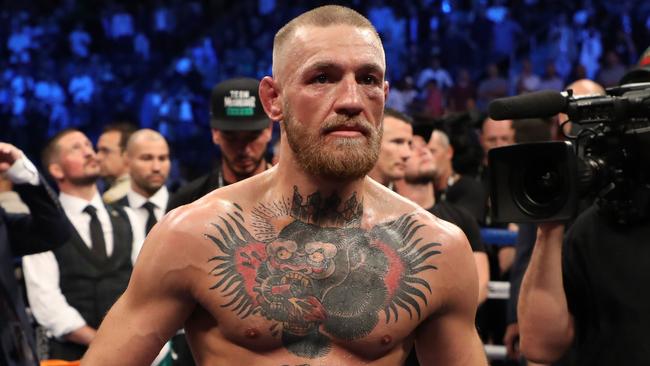 Conor McGregor stands in the ring after being defeated by Floyd Mayweather.