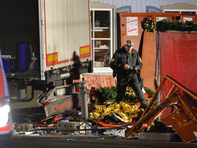 A policeman inspects the truck that crashed into a christmas market in Berlin, on December 19, 2016. Picture: AFP