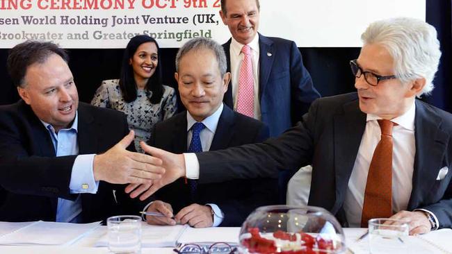 FUTURE PLANS: Brookwater Resort Investments CEO Richard Turner (left) shakes hands with Dusit Thani CEO David Shackleton while Maxsen Capital Hong Kong CEO Jimmy Chan (middle) looks on. Picture: Rob Williams