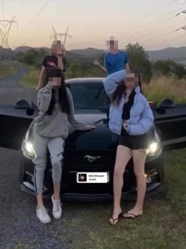 Youths posing with a Ford Mustang stolen from an address in Helensvale in pictures posted on social media.