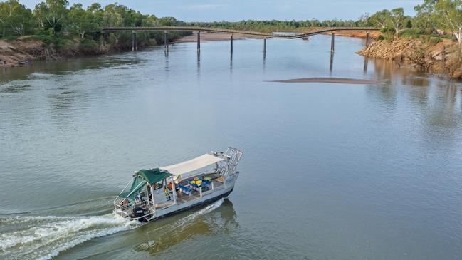 A new passenger ferry in operation near the damaged Great Northern Highway bridge over the Fitzroy River at Fitzroy Crossing, WA. Picture: Nathan Dyer