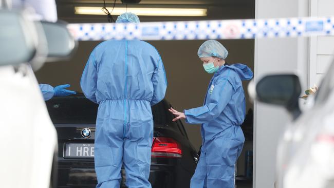 Forensics officers investigate the murder of bikie Shane Bowden. Picture: Annette Dew