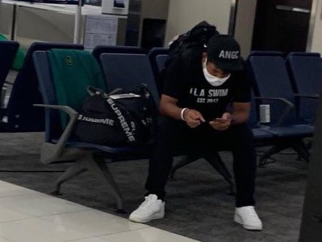 Hideki Matsuyama at Atlanta airport with his green jacket draped over the chair next to him