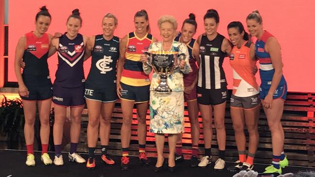 The eight AFLW club captains and long-time Western Bulldogs board member — and women’s footy pioneer — Susan Alberti with the AFLW premiership cup.