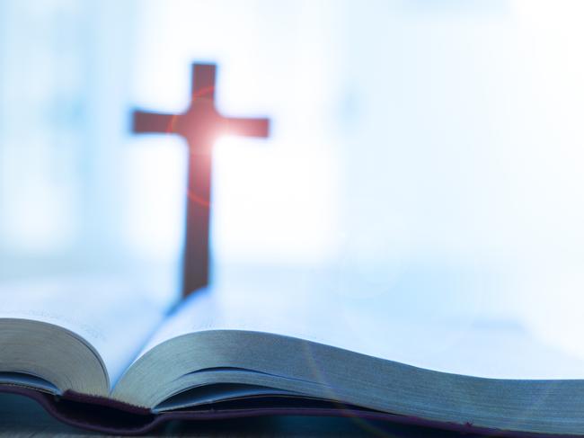 Bible and cross on desk. Cult Religion generic