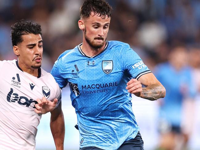 SYDNEY, AUSTRALIA - OCTOBER 21: Daniel Arzani of the Victory and Jordan Courtney-Perkins of Sydney FC compete for the ball during the A-League Men round one match between Sydney FC and Melbourne Victory at Allianz Stadium, on October 21, 2023, in Sydney, Australia. (Photo by Mark Kolbe/Getty Images)