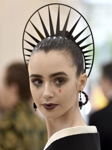A halo-like crown completes Lily Collins’ look at the 2018 Met Gala. Picture: AP