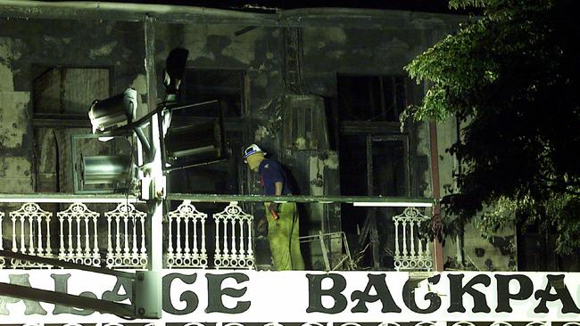 A fireman sifts through wreckage of the building.