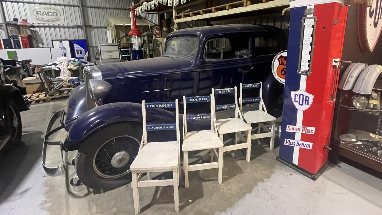 Vintage branded chairs and a blue 1933 Chevroletfrom Roadside Relics on Brisbane Road, Gympie.