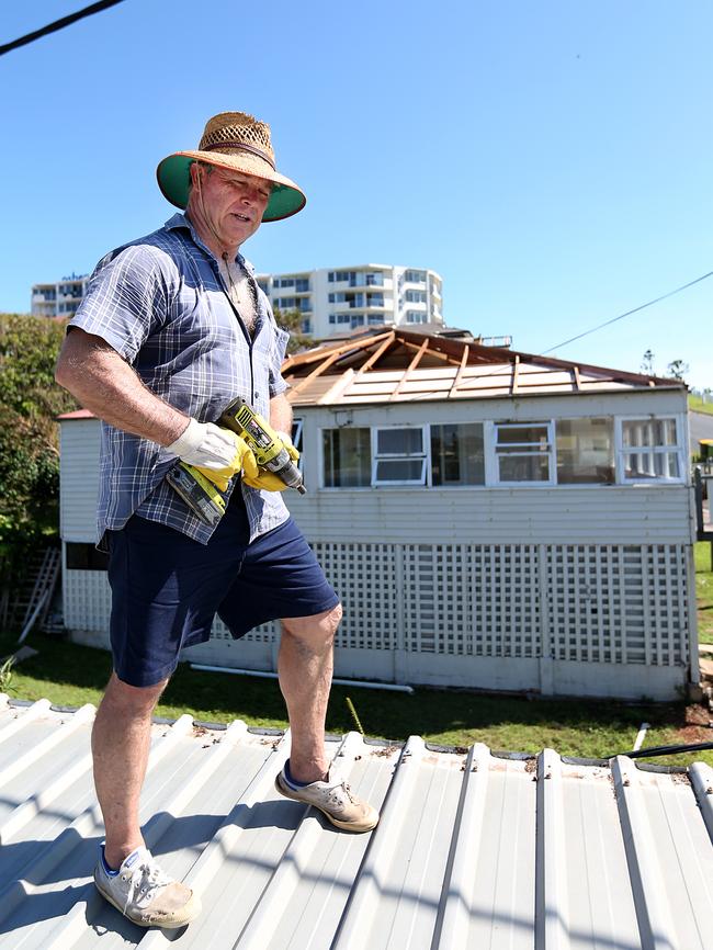 Cole Truton repairing the roof on his home in Yeppoon after Cyclone Marcia.