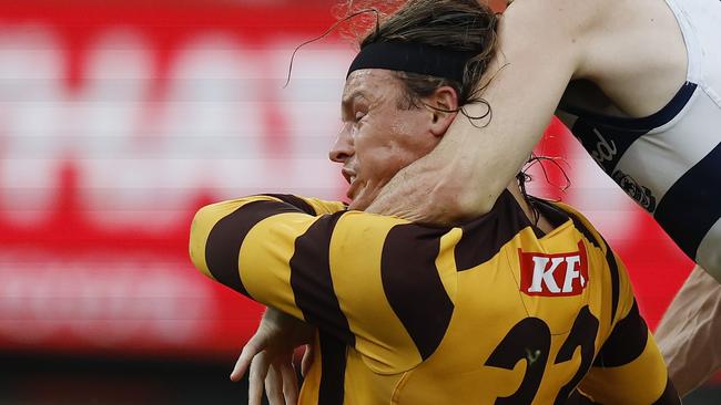 MELBOURNE , AUSTRALIA. April 1, 2024.  AFL Round 3.  Hawthorn vs Geelong at the MCG.   Jack Ginnivan of the Hawks gets takin high by Max Holmes but no free kick during the 3rd qtr.    . Pic: Michael Klein